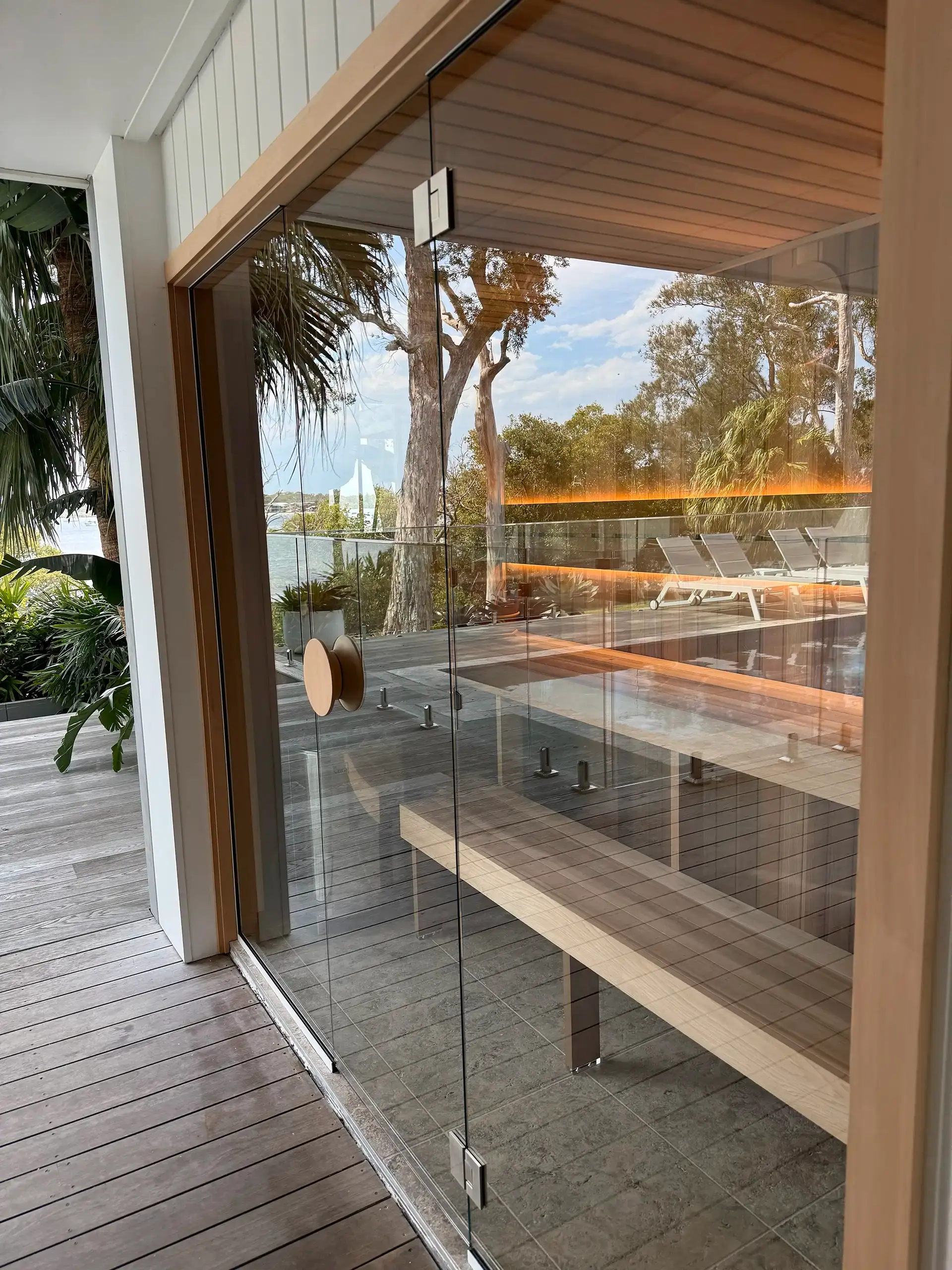 Custom cedar sauna on a waterfront deck