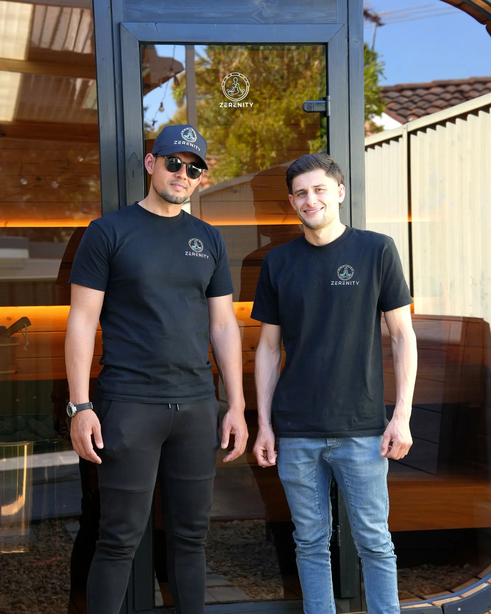 Jayden and Rhee in Zerenity shirts beside the Koda sauna